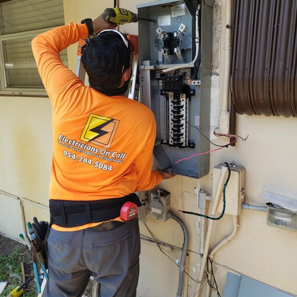 electrician installing panel
